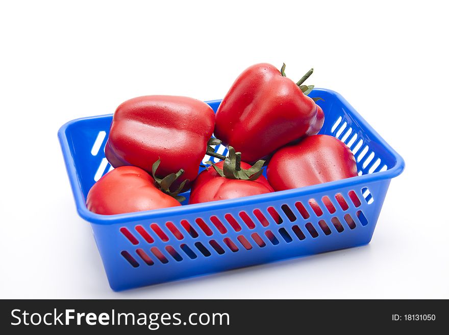 Tomato and red paprikas in the plastic basket