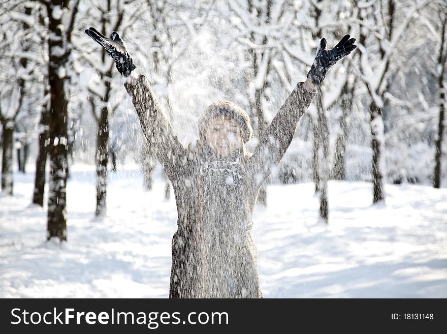 Beautiful young red-haired woman in winter park. Outdoor shot.