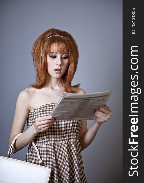 Portrait of red-haired girl with newspaper. 60s style. Portrait of red-haired girl with newspaper. 60s style.