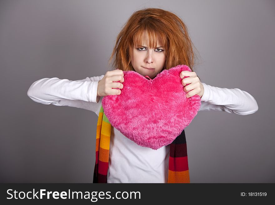 Sad girl with heart. St. Valentine Day. Studio shot.