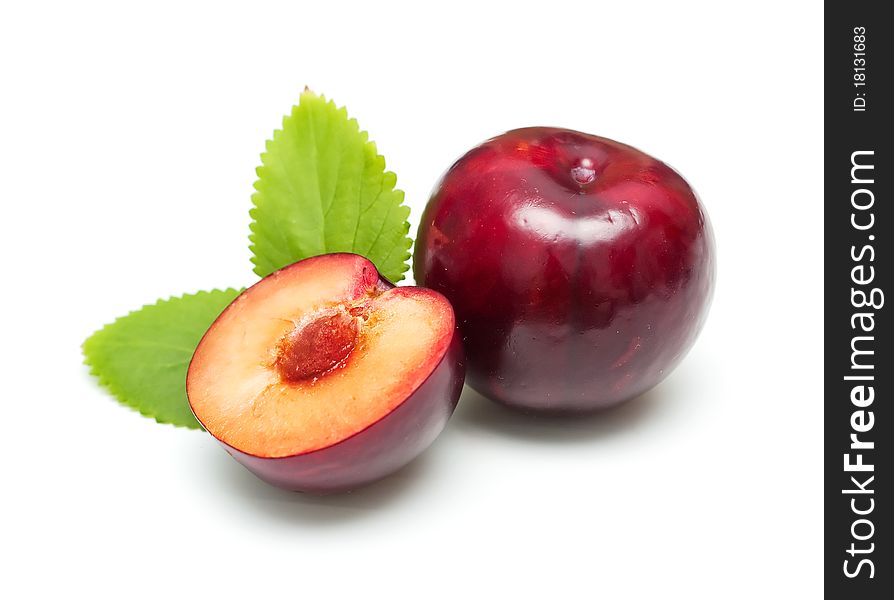 Ripe bright plums closeup on white background. Ripe bright plums closeup on white background