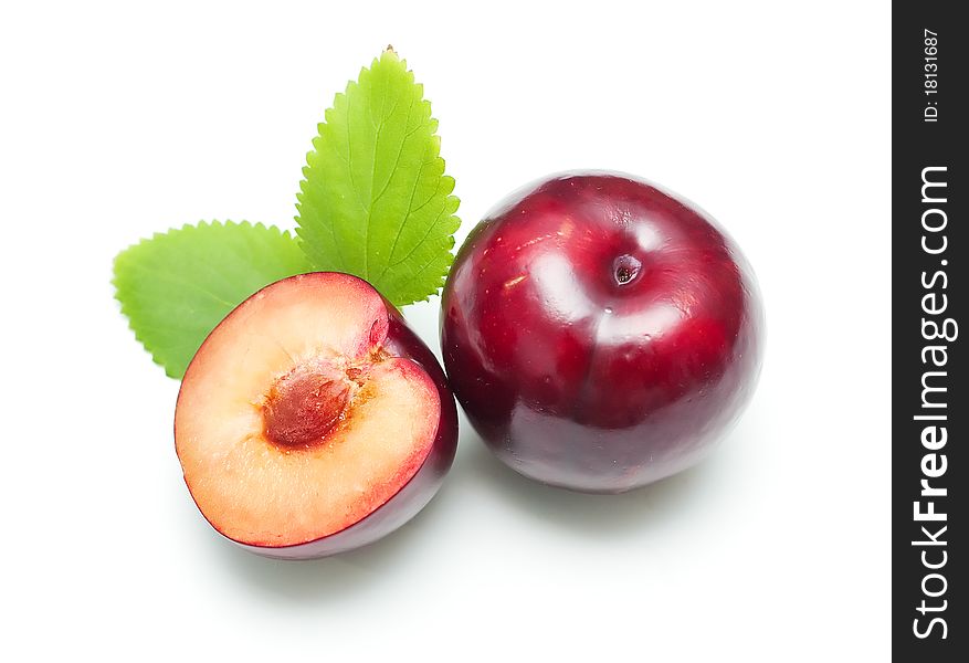 Ripe bright plums closeup on white background. Ripe bright plums closeup on white background