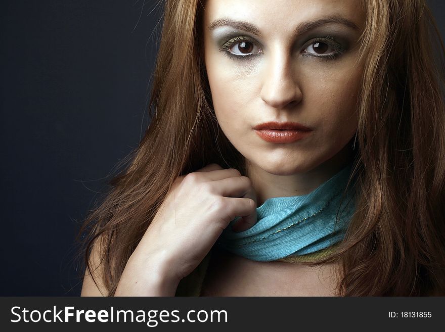 Closeup portrait of a red hair woman with blue scarf, studio shot. Closeup portrait of a red hair woman with blue scarf, studio shot