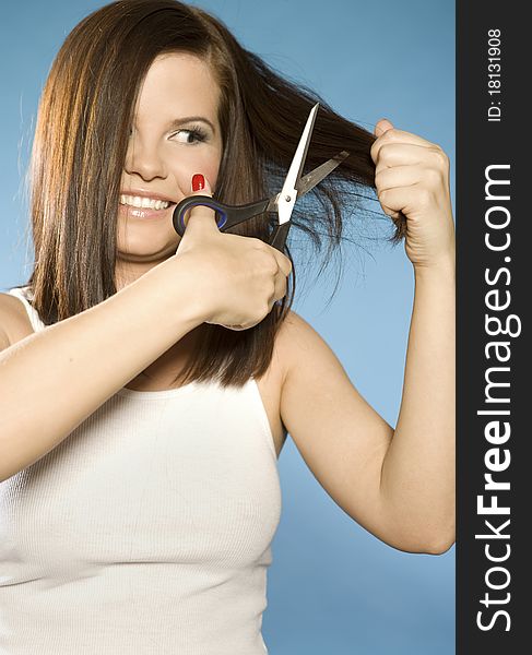 Beautiful brunette model cutting hair