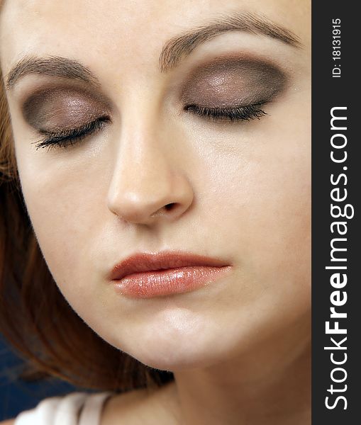 Closeup portrait of a woman, eyes closed, make-up shot