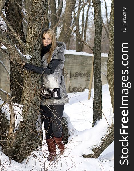 Smiling girl walking in winter forest