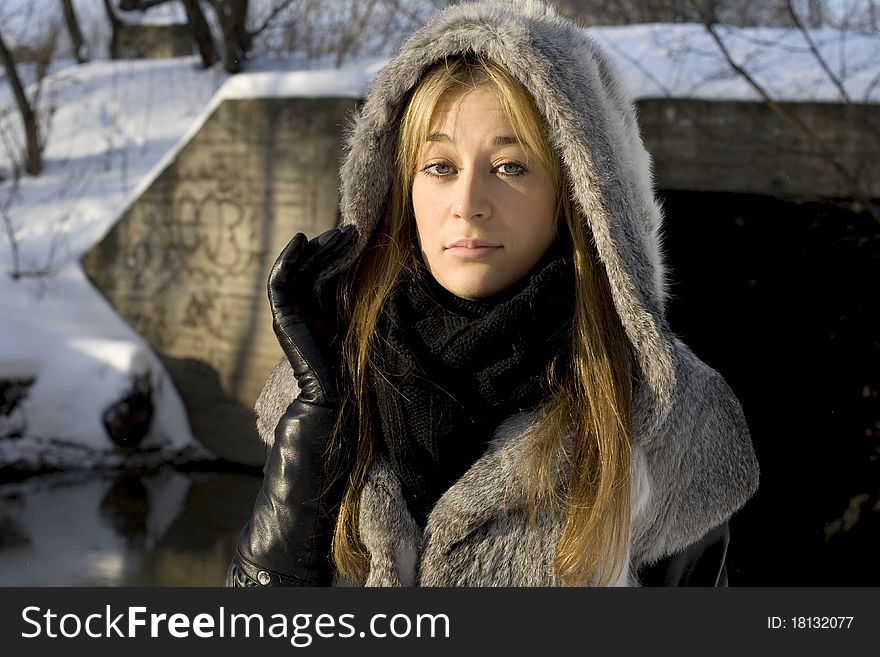 Smiling girl walking in winter forest