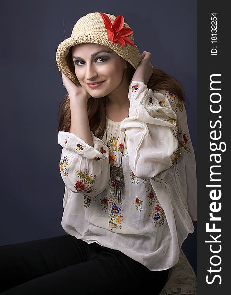 Pretty hippie woman with hat and flower looking at the camera and smiling. Pretty hippie woman with hat and flower looking at the camera and smiling