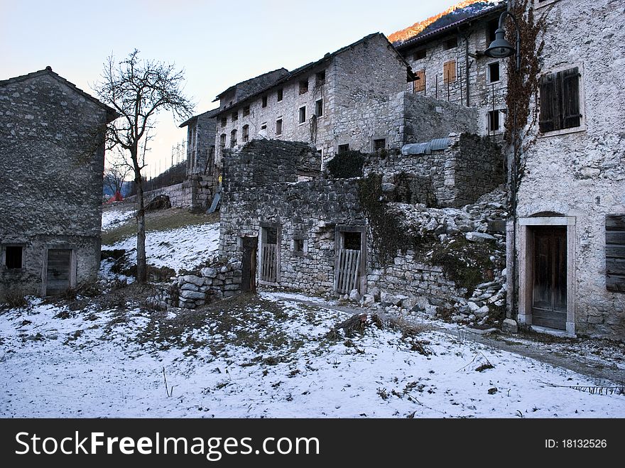 An abandoned old city with some houses collapsed and the snow on the ground. An abandoned old city with some houses collapsed and the snow on the ground