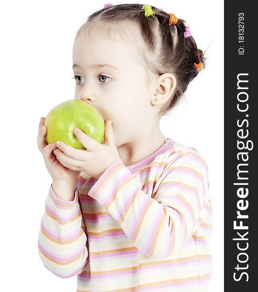 The child chewing an apple on a white background. The child chewing an apple on a white background