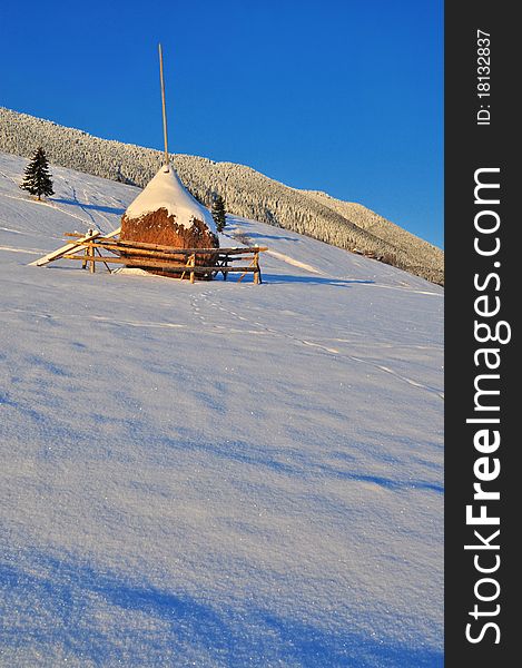 A haystack in a bright winter rural landscape. A haystack in a bright winter rural landscape