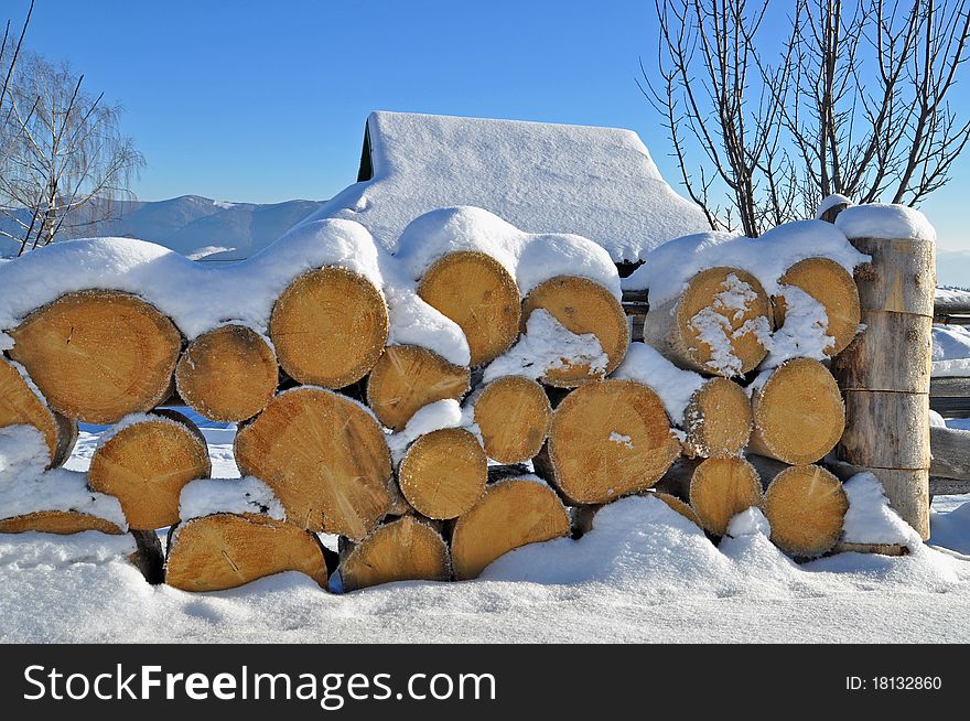 Fire wood under snow in a winter landscape