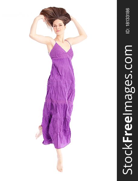 Elegant woman in a purple dress holding her hair