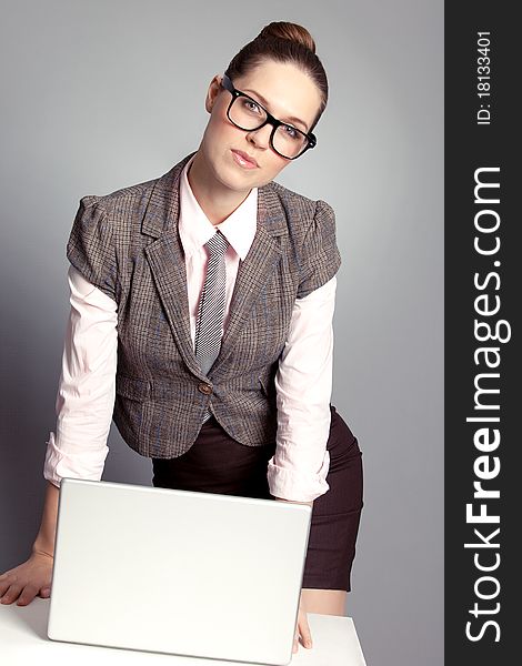 Cute business lady standing by the table