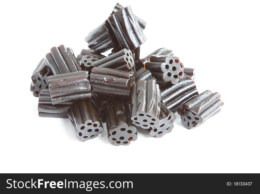 A pile of black liquorice isolated against a white background