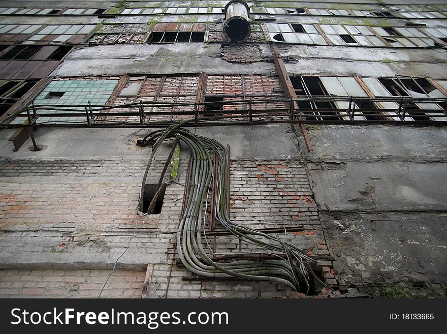 Old abandoned factory brick wall and windows with broken glass. Old abandoned factory brick wall and windows with broken glass