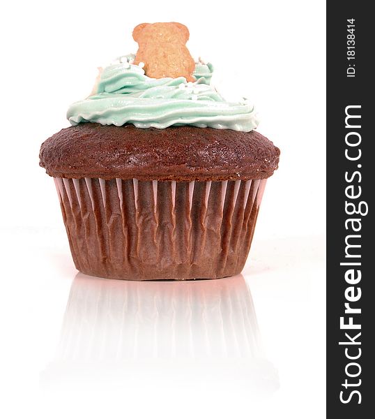Chocolate cupcake decorated with a teddy bear and blue frosting. Chocolate cupcake decorated with a teddy bear and blue frosting