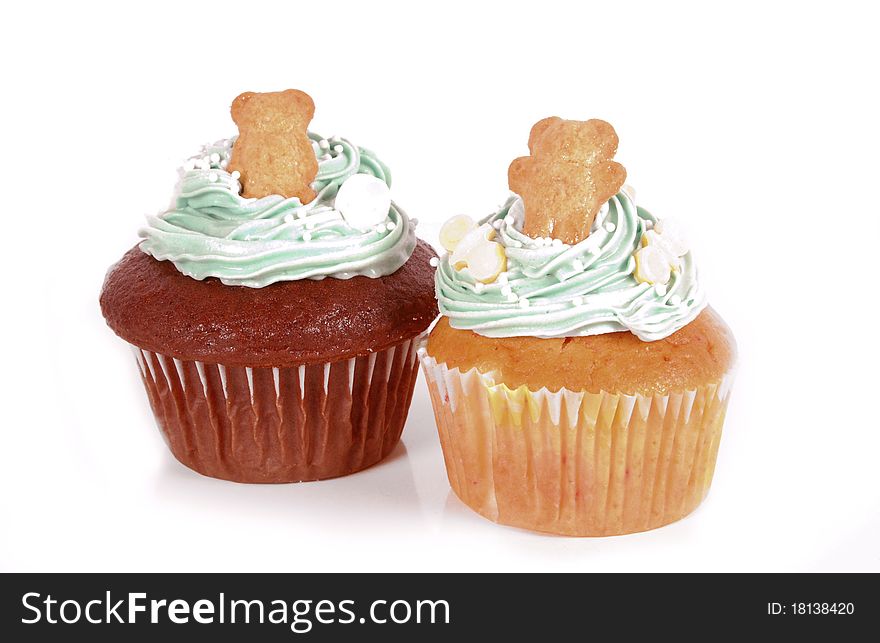 Two cupcake decorated with a teddy bear and blue frosting. Two cupcake decorated with a teddy bear and blue frosting