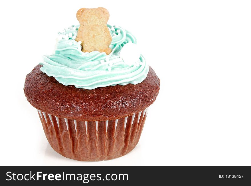 Chocolate cupcake decorated with a teddy bear and blue frosting. Chocolate cupcake decorated with a teddy bear and blue frosting