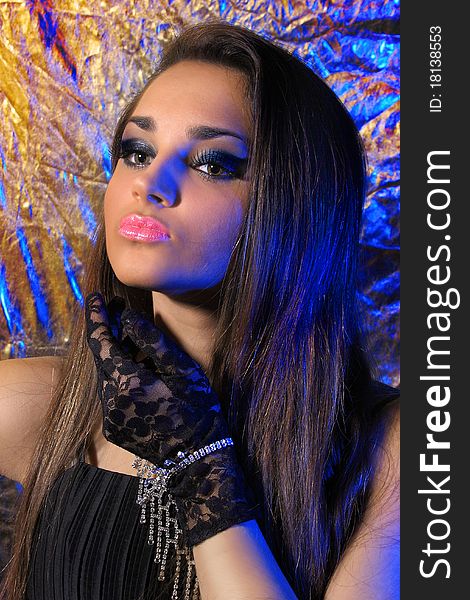 Wellness. Make-up & cosmetics. Portrait of Luxury woman with healthy long hair on silver with shades of blue background. Wellness. Make-up & cosmetics. Portrait of Luxury woman with healthy long hair on silver with shades of blue background