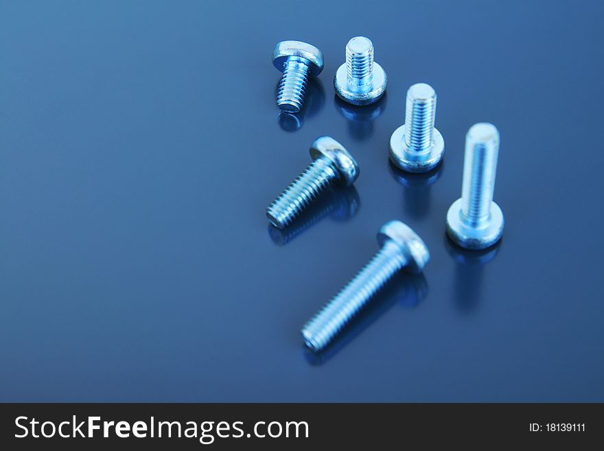 Metal bolts on a grey background