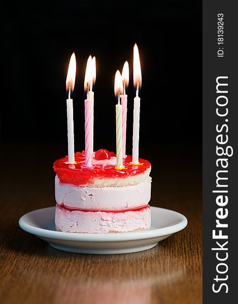 Cake with candle on wood table