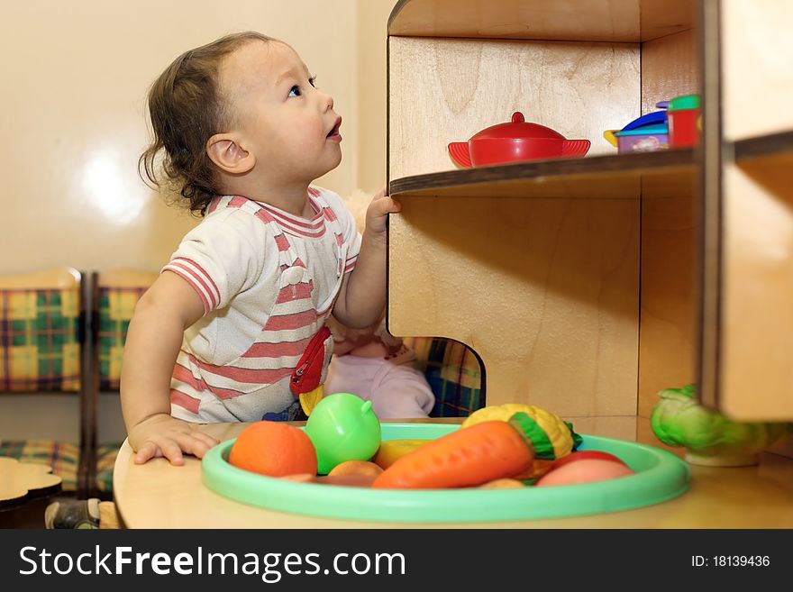 Baby playing with toy and looking up