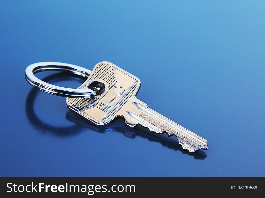 Key with ring on a grey background. Key with ring on a grey background