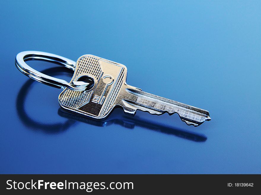 Key with ring on a grey background. Key with ring on a grey background