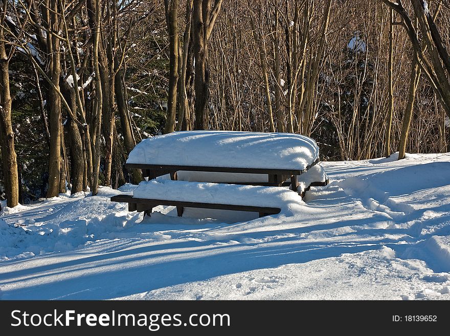 A soft blanket of snow covers up a pic-nic table. A soft blanket of snow covers up a pic-nic table