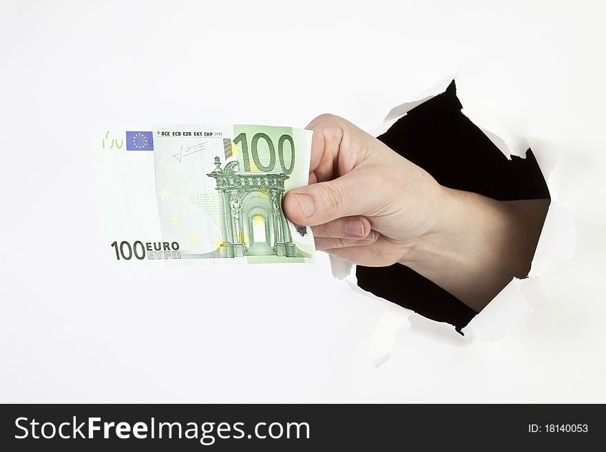 A men's hand breaks through a hole and shows a 100Euro banknote. A men's hand breaks through a hole and shows a 100Euro banknote