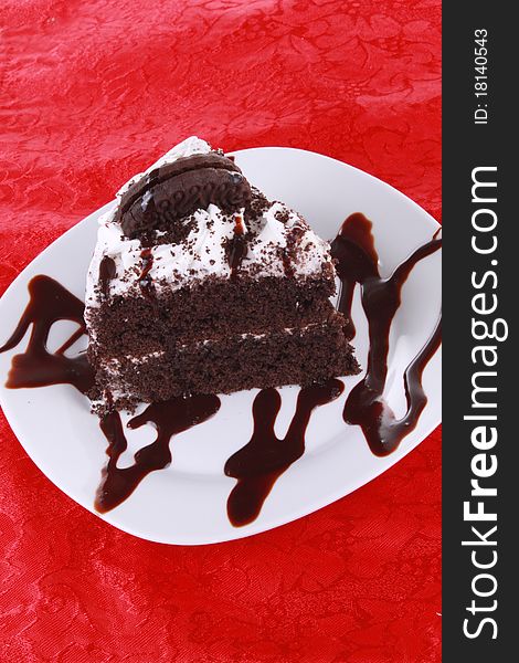 Chocolate cake on bright red tablecloth