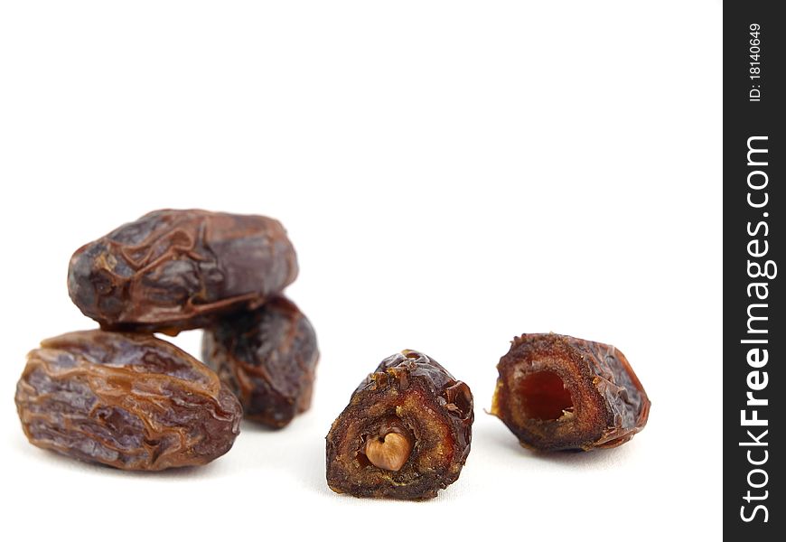 Dried black dates isolated on white background