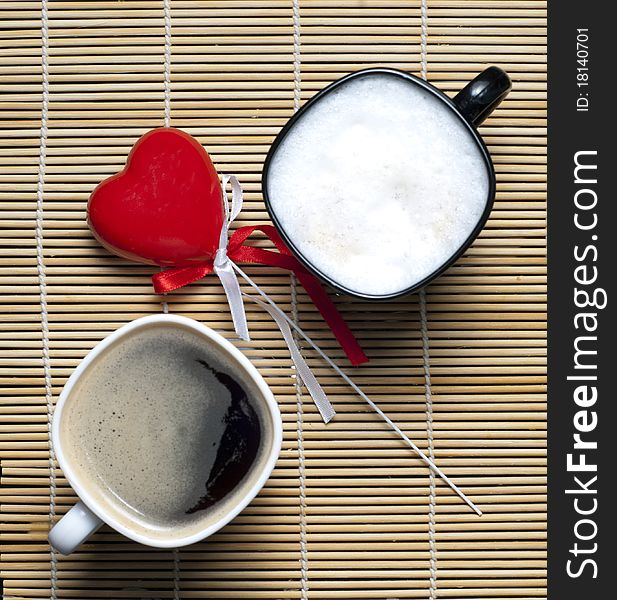 Two coffee cups and a heart