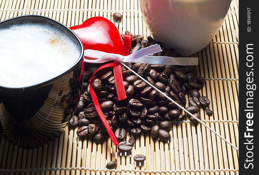 Two coffee cups, heart and beans close shot. Two coffee cups, heart and beans close shot