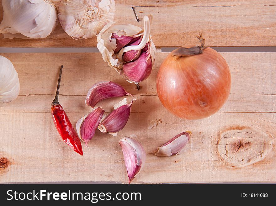 Garlics and onion on old wood