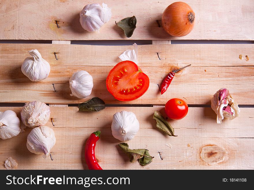 Onion, garlic and pepper on a wooden desk