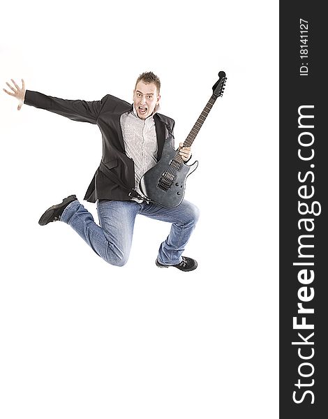 Young guy jumping with guitar