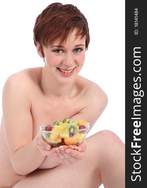 Beautiful healthy naked girl holding bowl of fruit