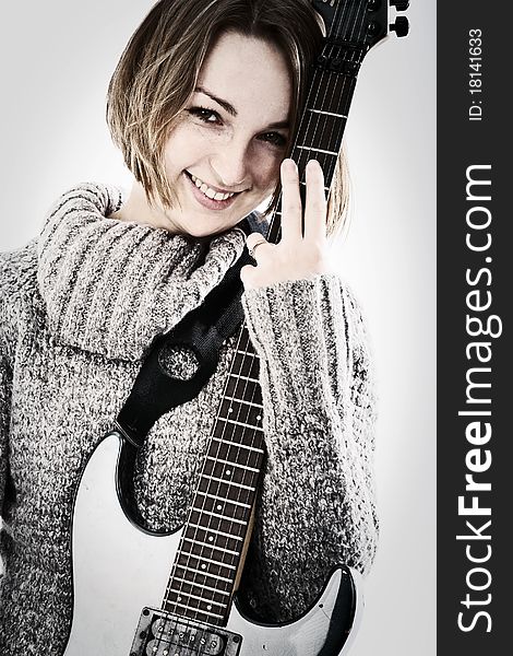 Portrait of a pretty young woman with guitar
