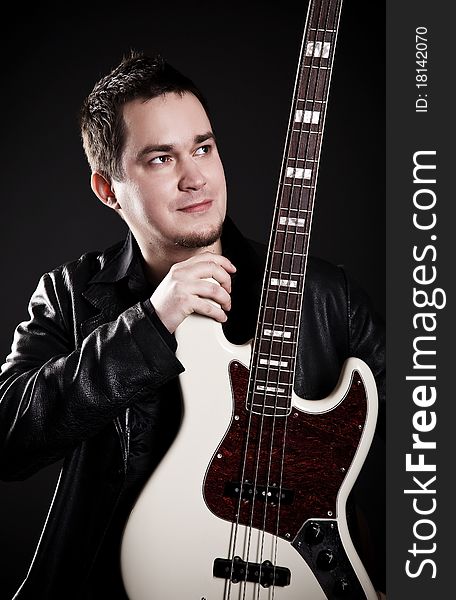 Portrait of the guitarist on a black background