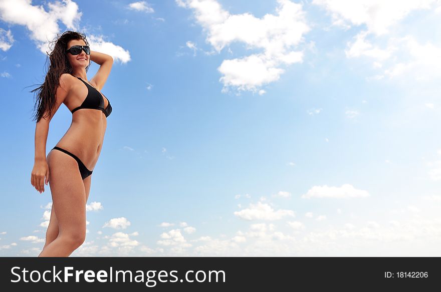 Beautiful girl on the beach and blue sky