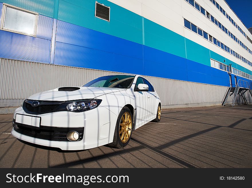 White sport car on background industrial building