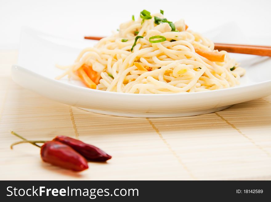 Thai food with dried chili peppers and chopsticks