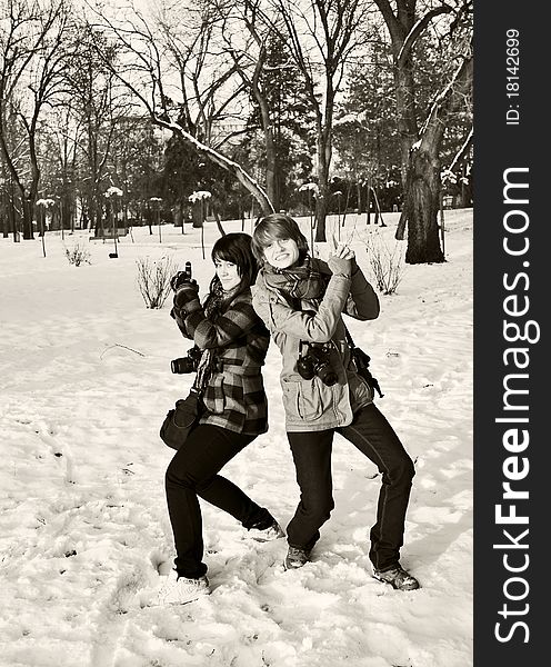 Two girls photographers having fun in the park