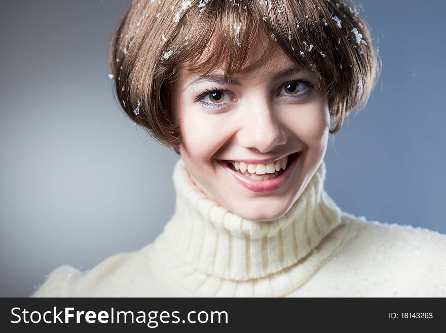 Young beautiful girl rejoices to snow, On a dark blue background