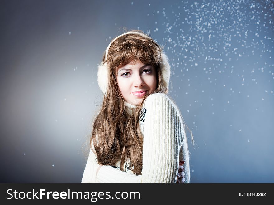 Young beautiful girl rejoices to snow, On a dark blue background