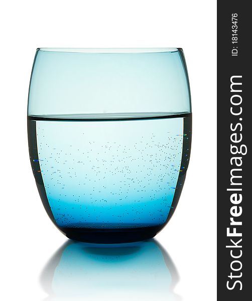 Glass with pure mineral water and bubbles on white