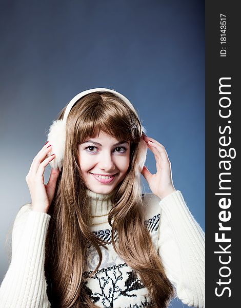 Young beautiful girl rejoices to snow, On a dark blue background