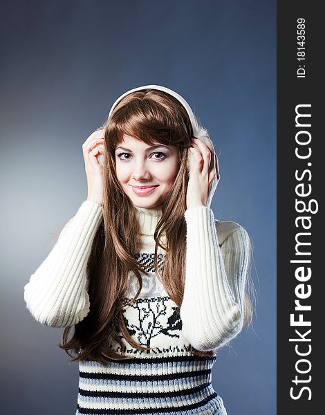 Young beautiful girl rejoices to snow, On a dark blue background